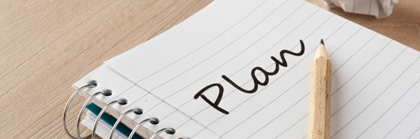 Notebook and pen with plan written on it 